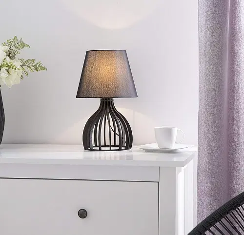 Side view of wooden table lamp showing vertical wooden strips and fabric shade.